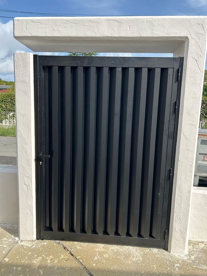 Puerta peatonal negra con lamas en A Coruña